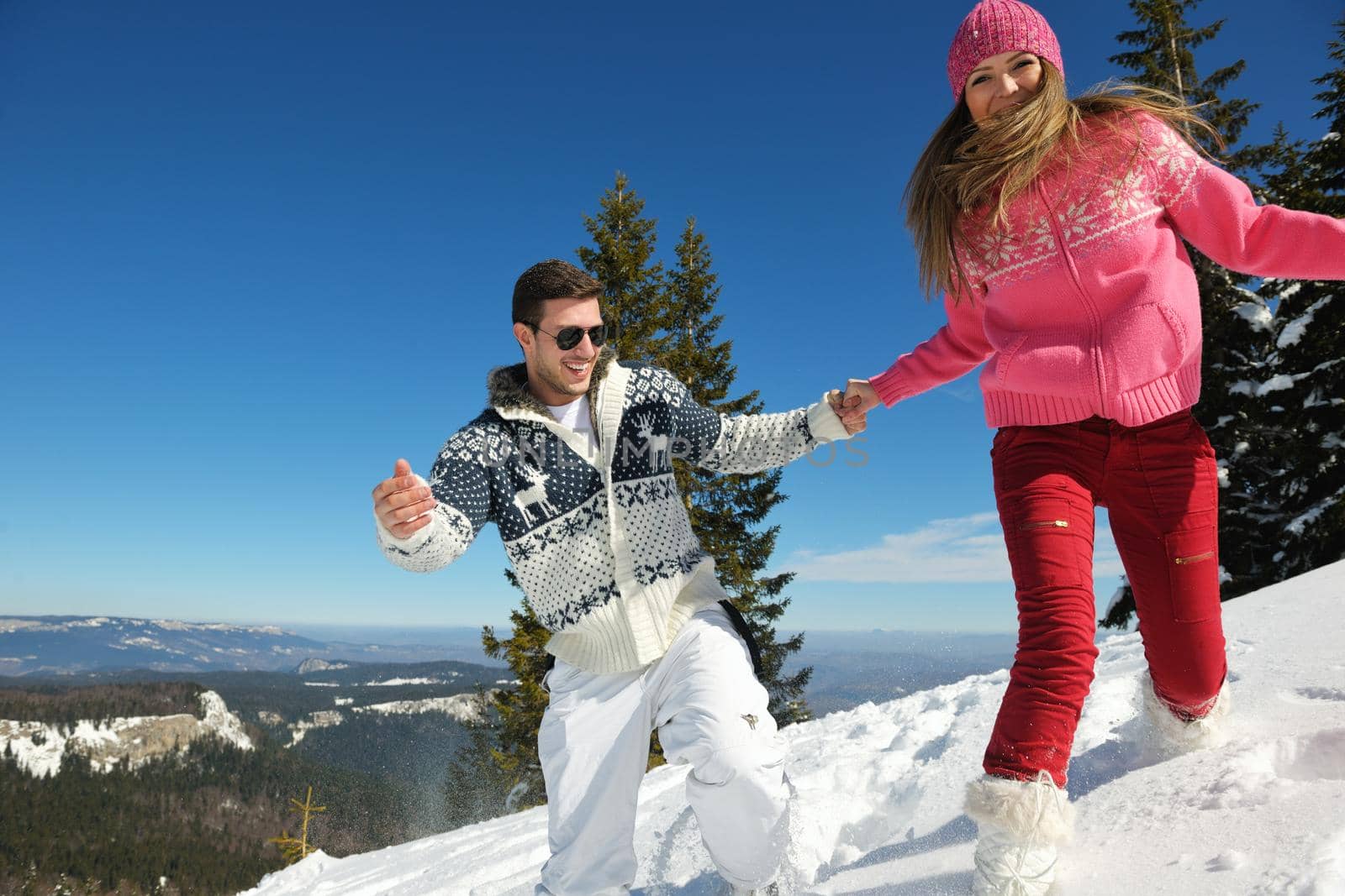 Young Couple In winter Snow Scene at  beautiful sunny day