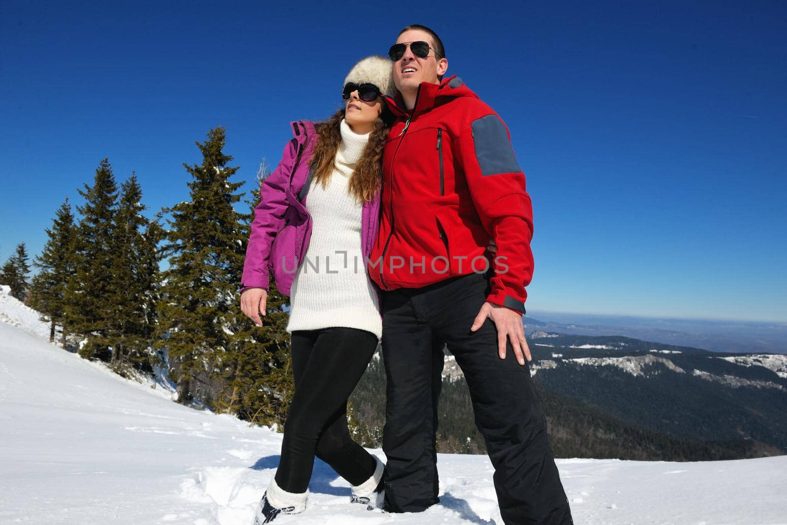 Young Couple In winter Snow Scene at  beautiful sunny day