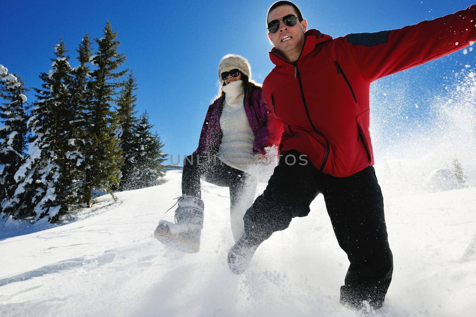 Young Couple In winter Snow Scene at  beautiful sunny day