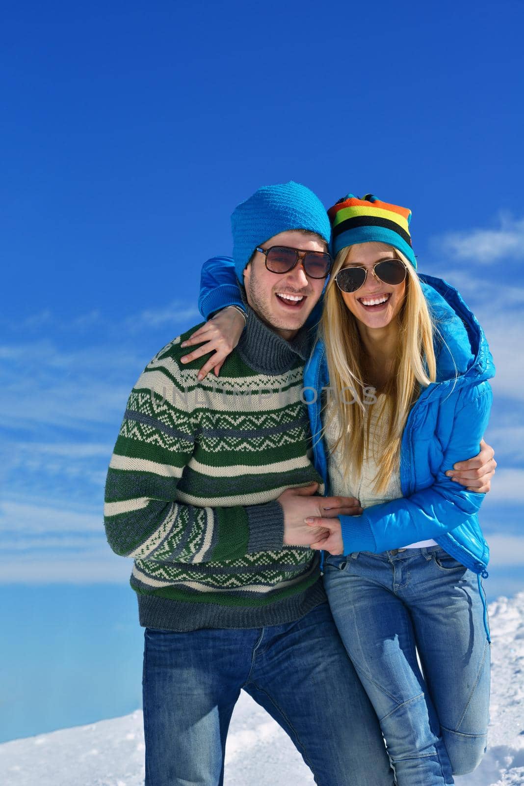 Young Couple In winter Snow Scene at  beautiful sunny day