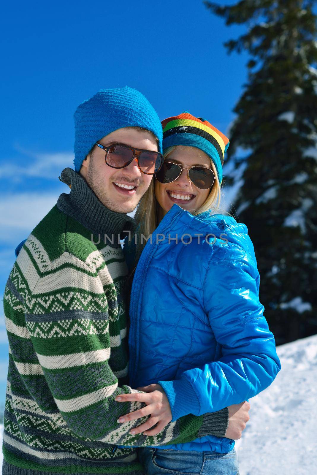 Young Couple In winter Snow Scene at  beautiful sunny day