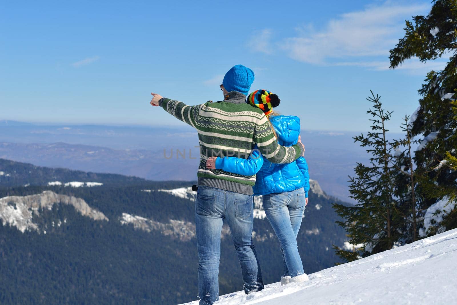 Young Couple In winter Snow Scene at  beautiful sunny day