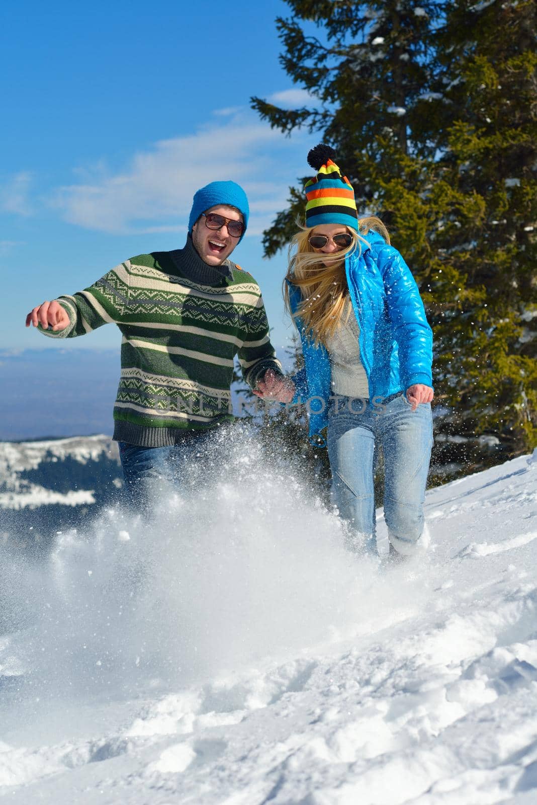 Young Couple In winter Snow Scene at  beautiful sunny day