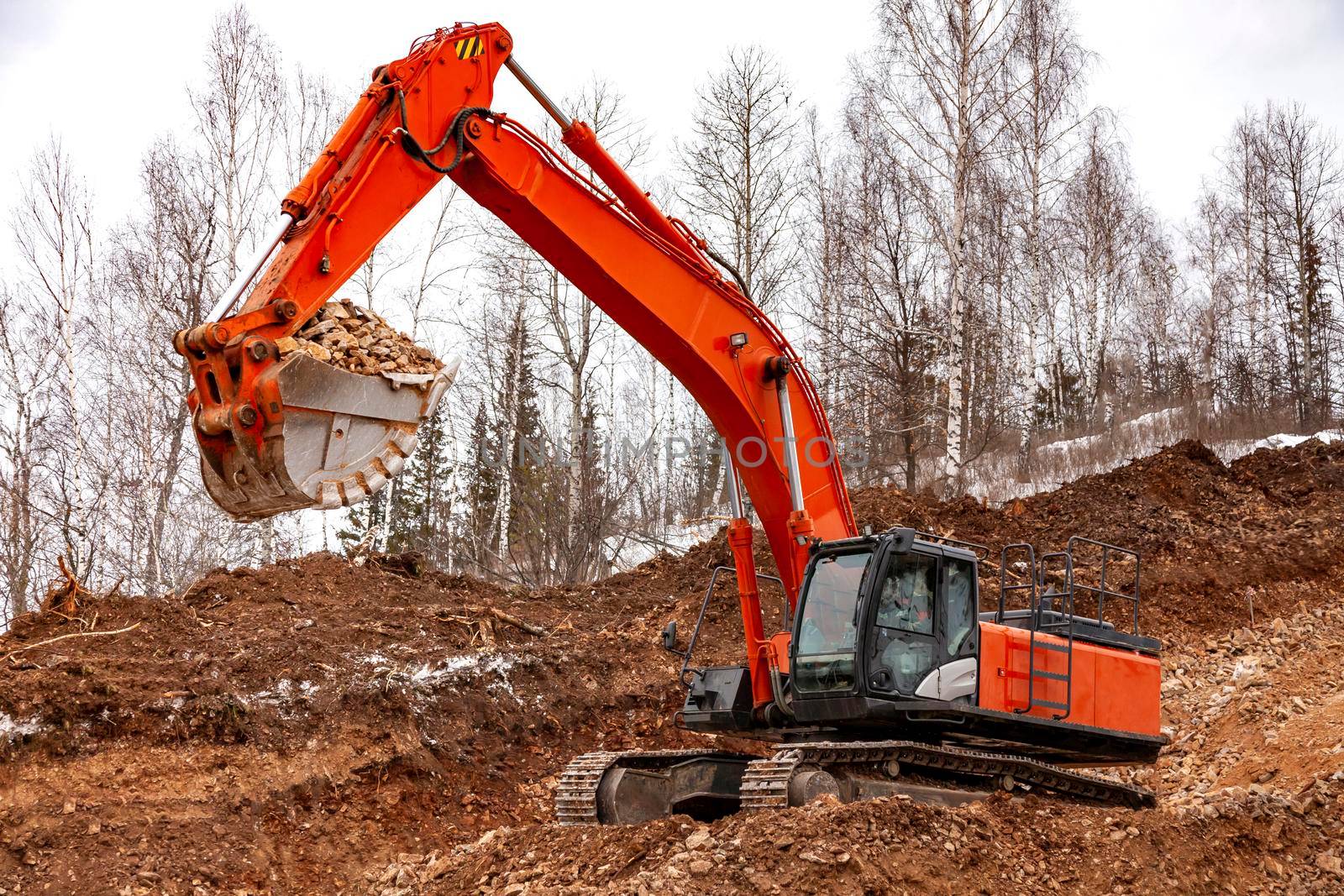 Modern excavator building a road in the forest by Nobilior
