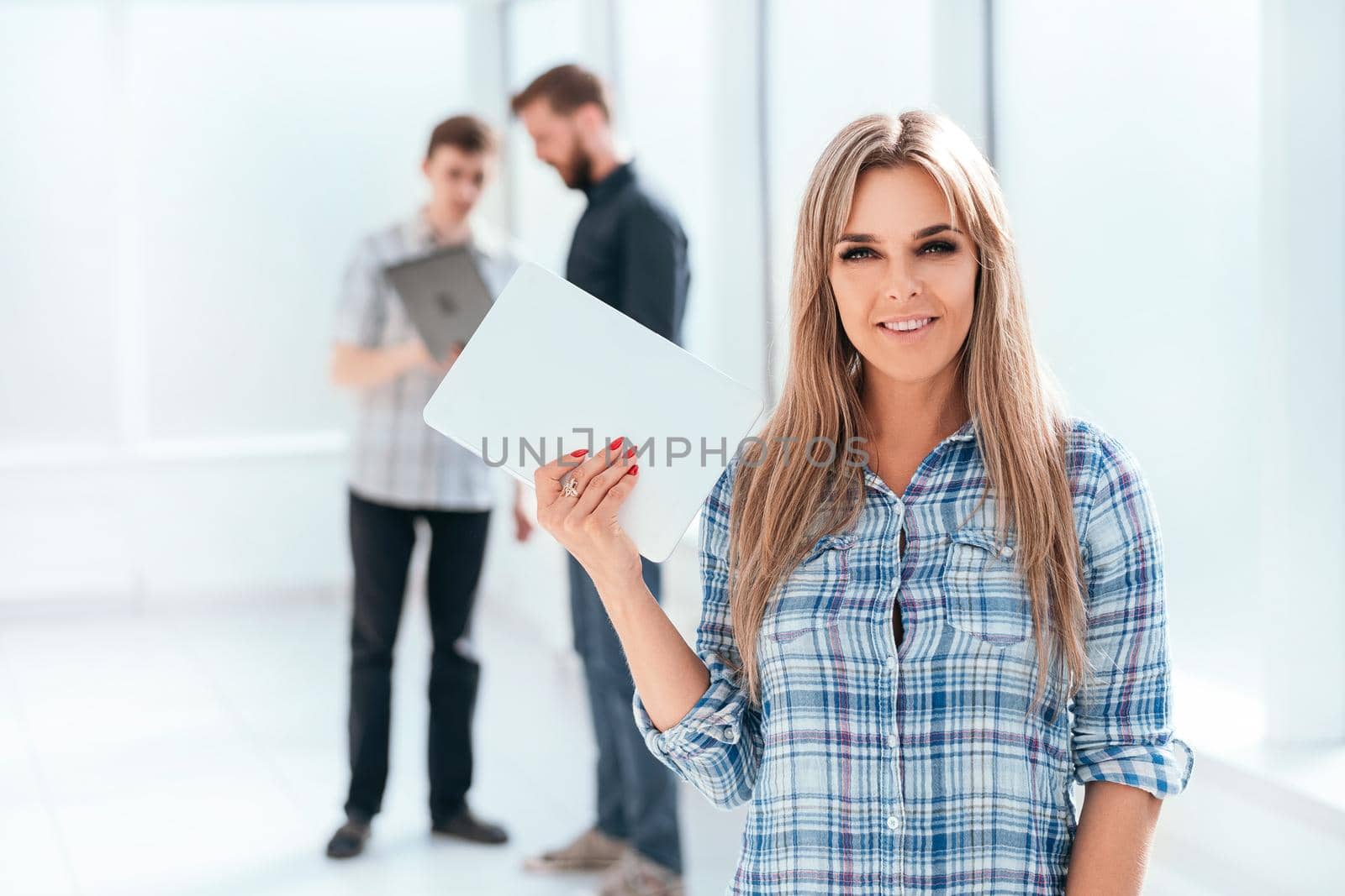 young businesswoman with digital tablet standing in the office. photo with copy space