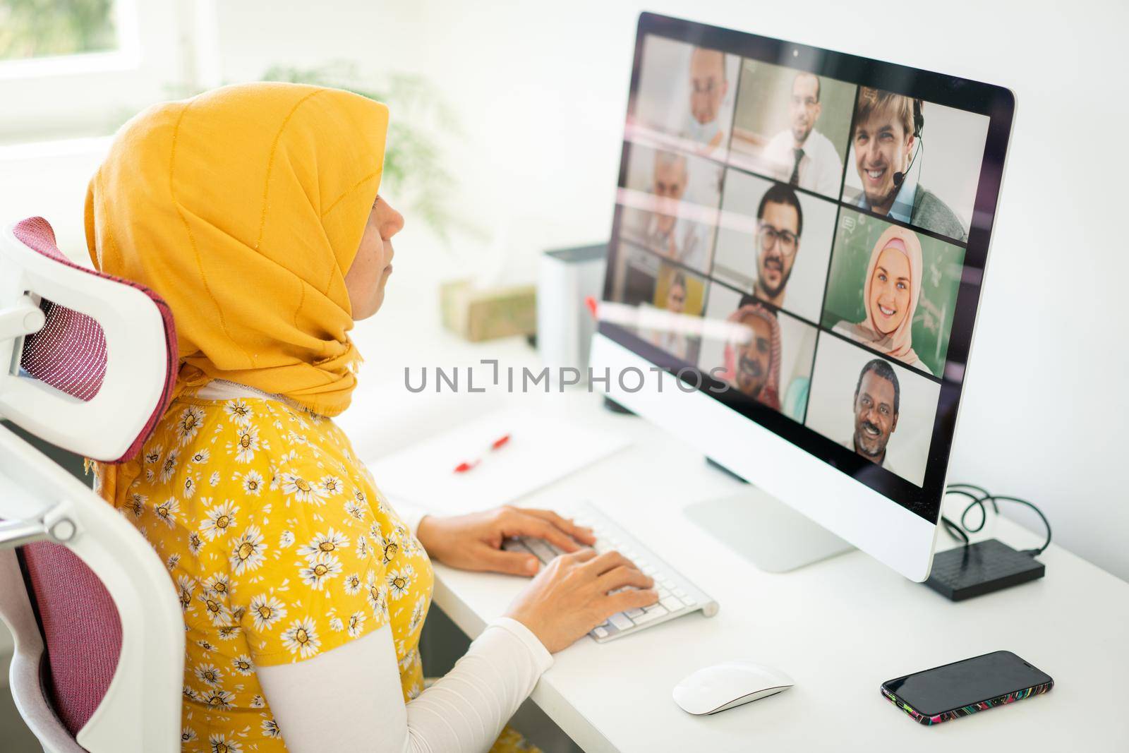 Middle Eastern businesswoman having online conference at home by Zurijeta