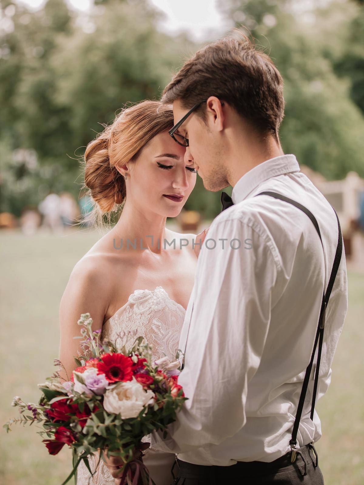 close up. portrait of happy newlyweds on blurred background.