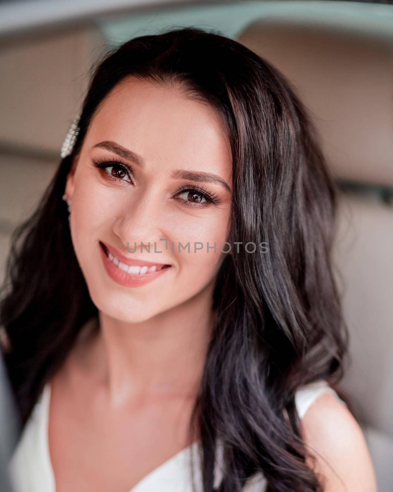 close up. attractive bride sitting in a chic car