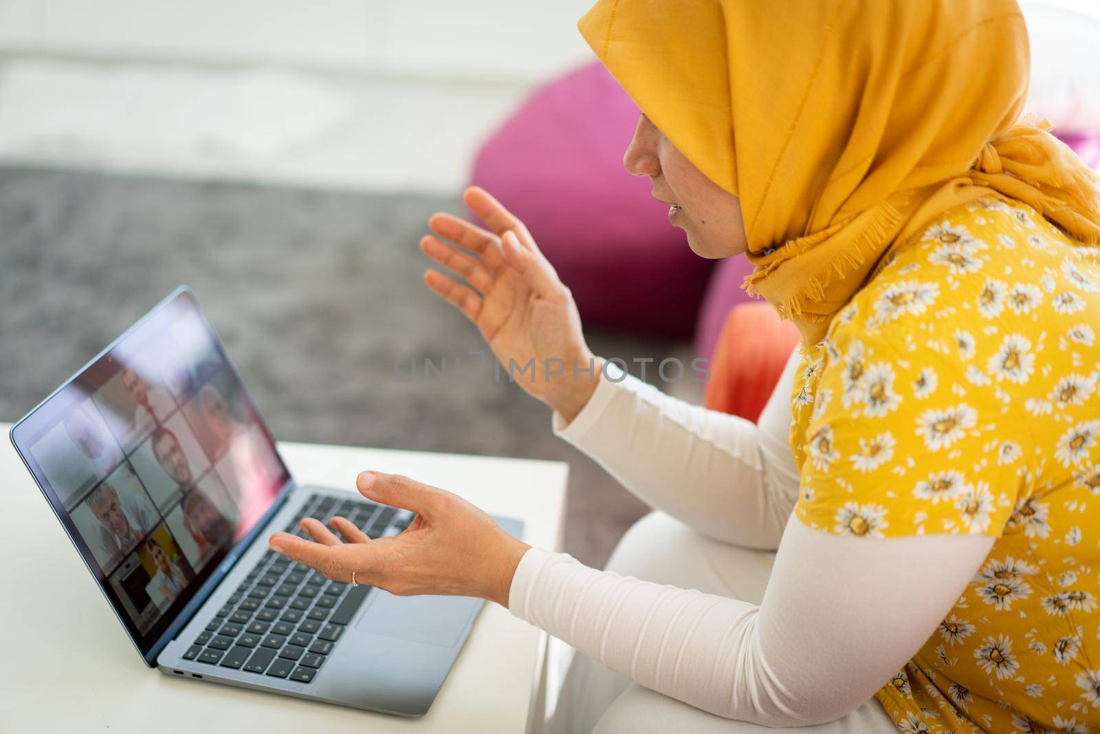 Middle Eastern businesswoman having online conference on tablet by Zurijeta