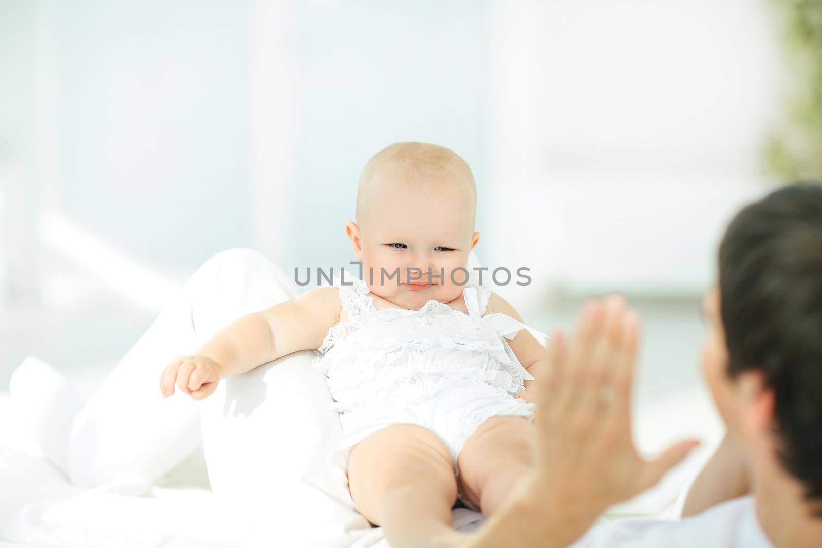 Handsome young dad is playing with his cute baby,concept of fatherhood