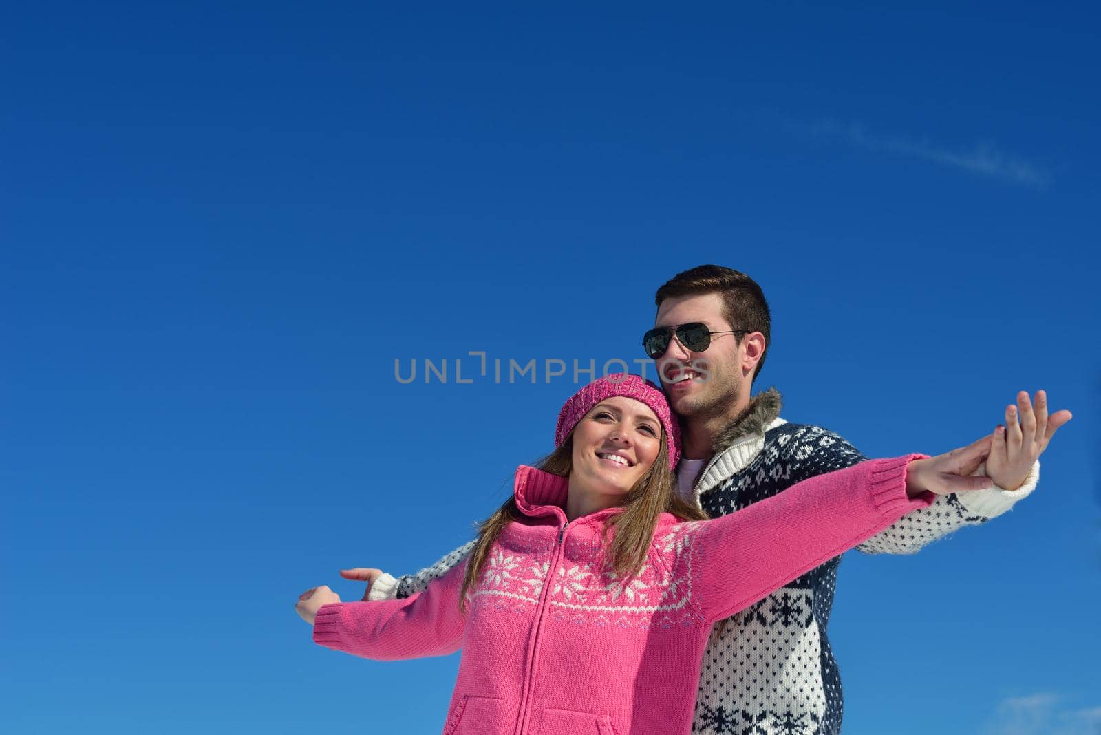 Young Couple In winter Snow Scene at  beautiful sunny day