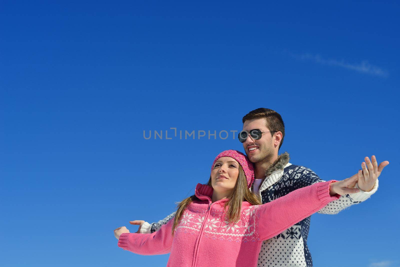 Young Couple In winter Snow Scene at  beautiful sunny day