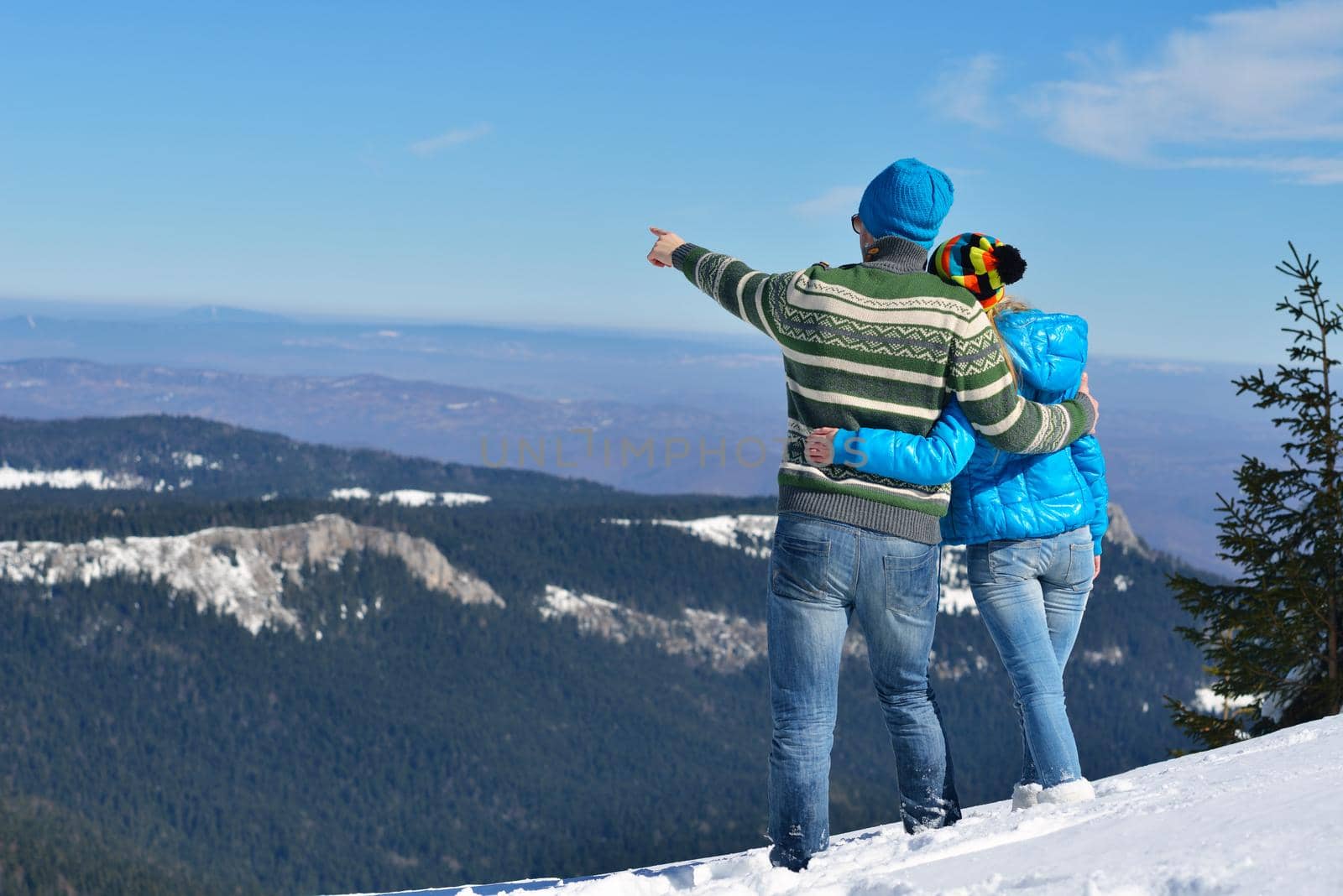 Young Couple In winter Snow Scene at  beautiful sunny day