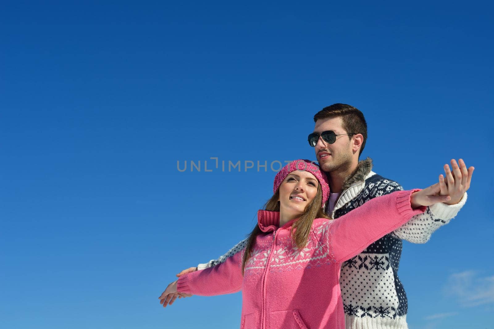 Young Couple In winter Snow Scene at  beautiful sunny day