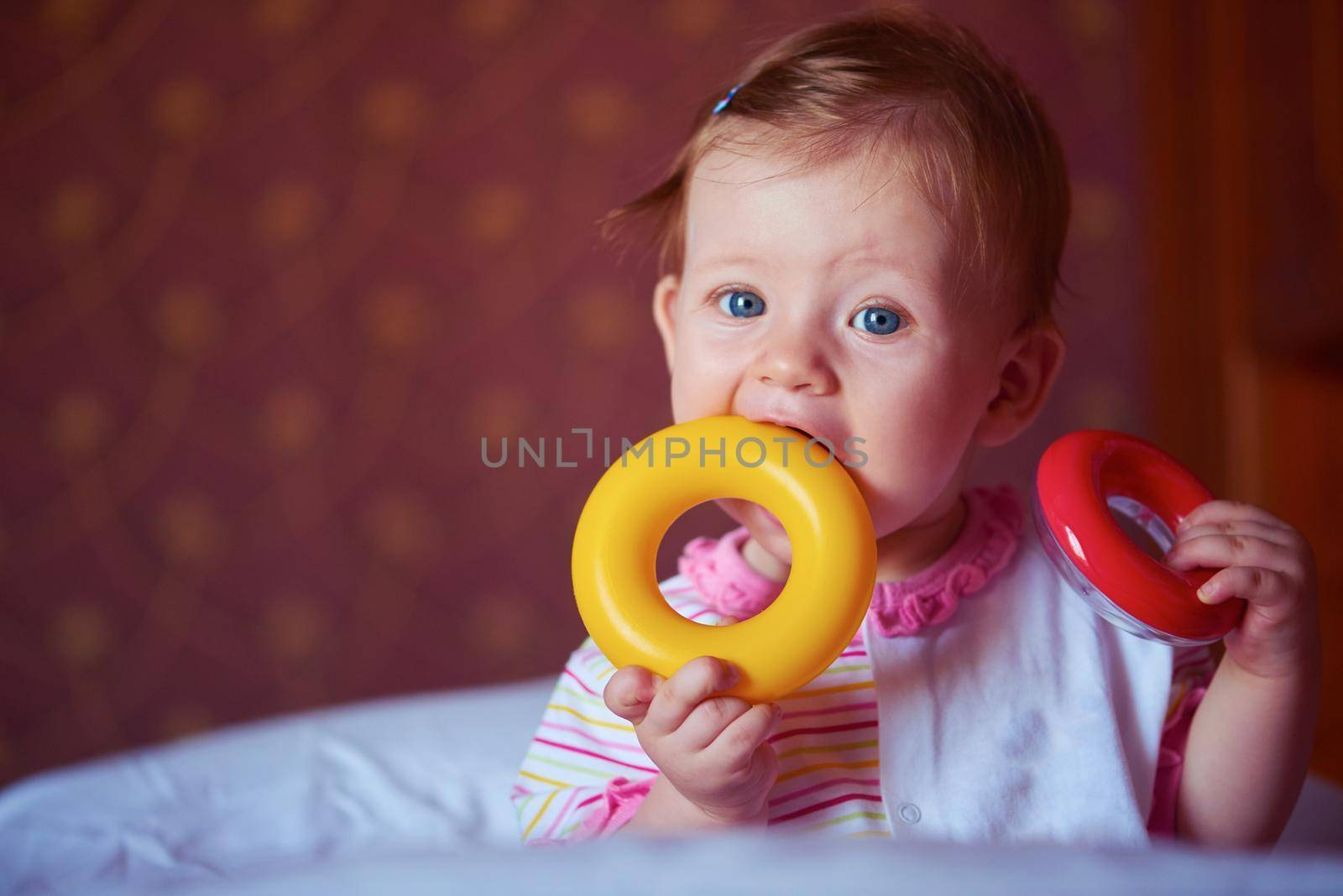 baby playing with toys at home by dotshock