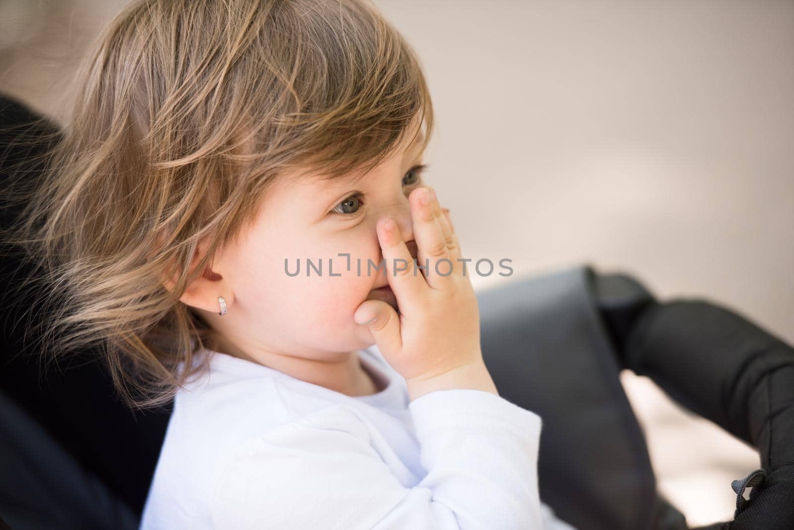 little and very beautiful baby girl sitting in the pram and waiting for mom