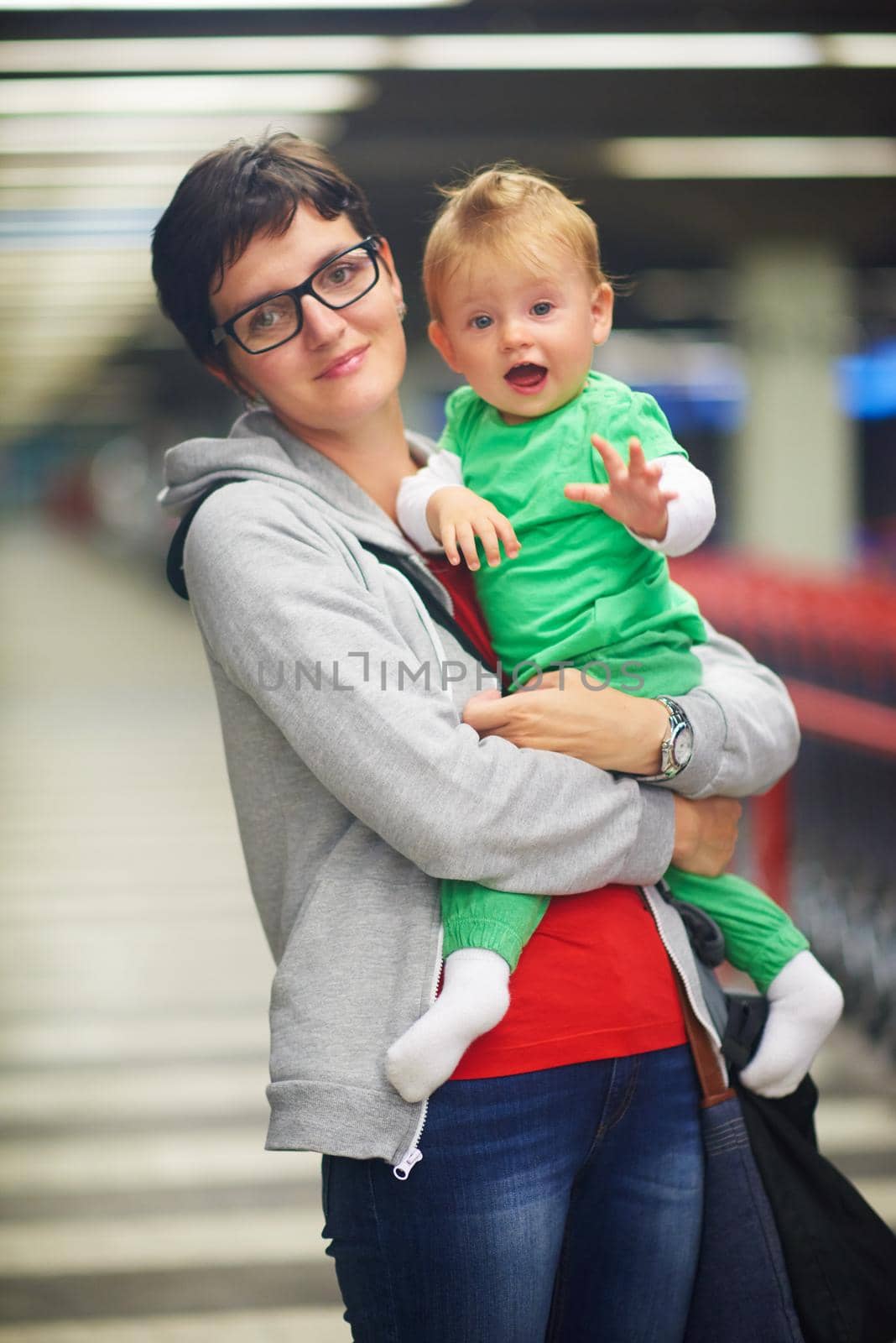 young mother with baby in shopping mall supermarket store buying food and grocery