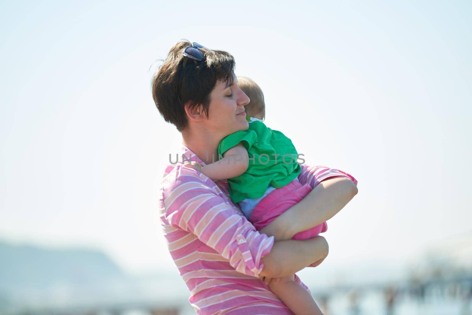 mom and baby on beach  have fun by dotshock