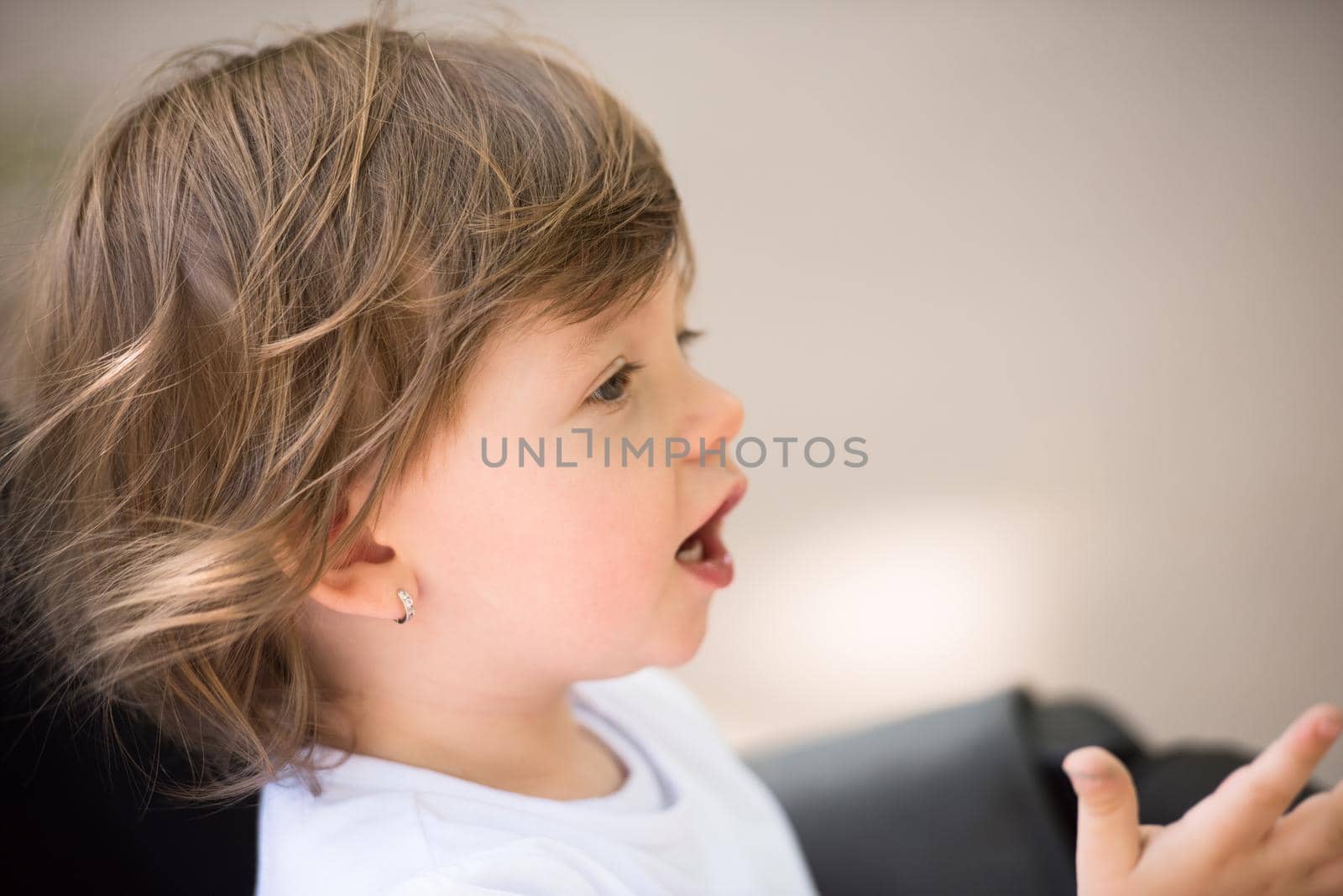 little and very beautiful baby girl sitting in the pram and waiting for mom