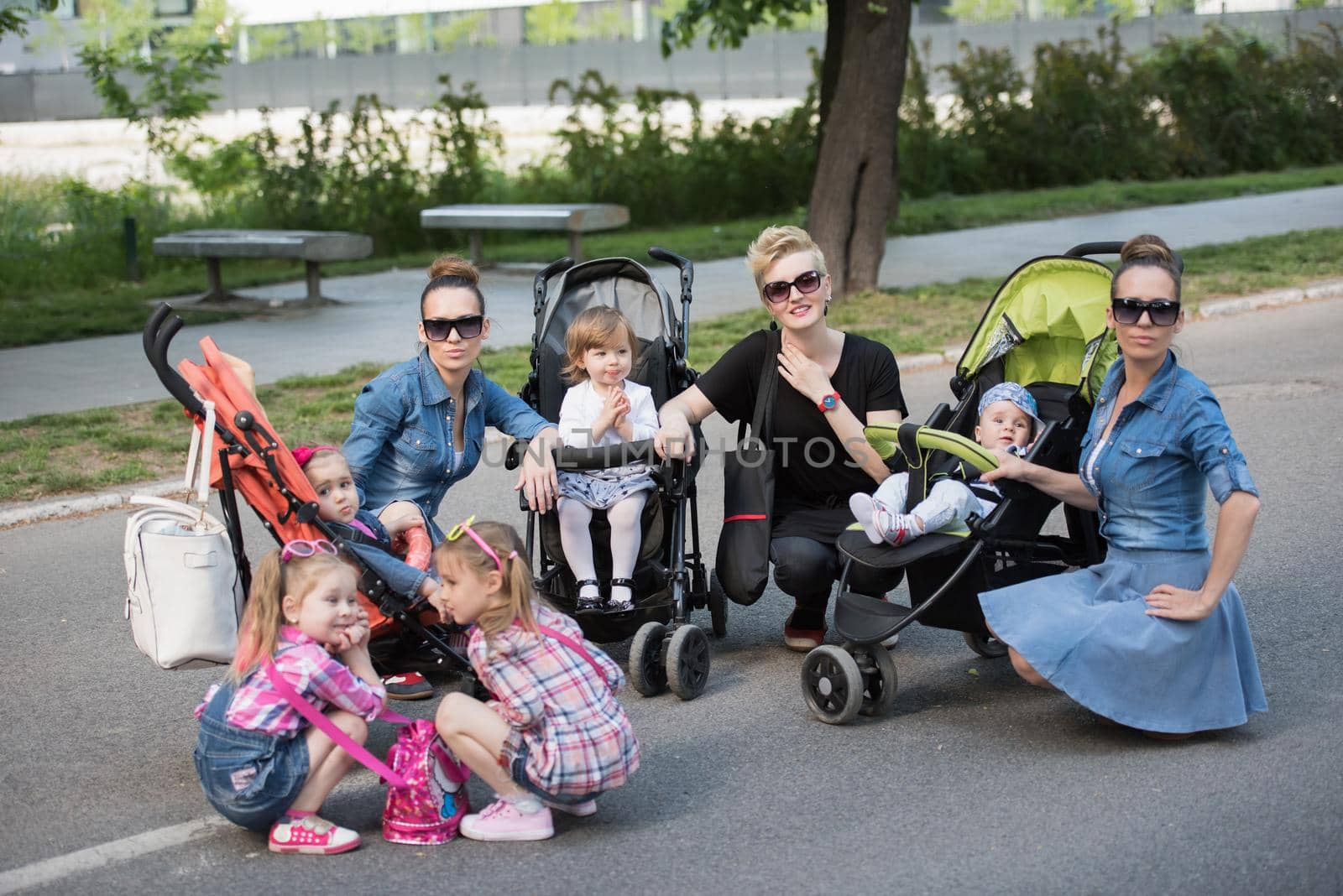 portrait of a group of young beautiful mother with children on a sunny day in the park