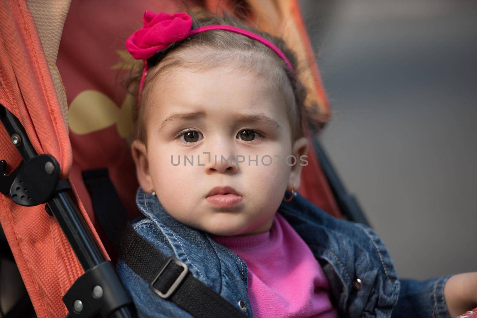 baby girl sitting in the pram by dotshock