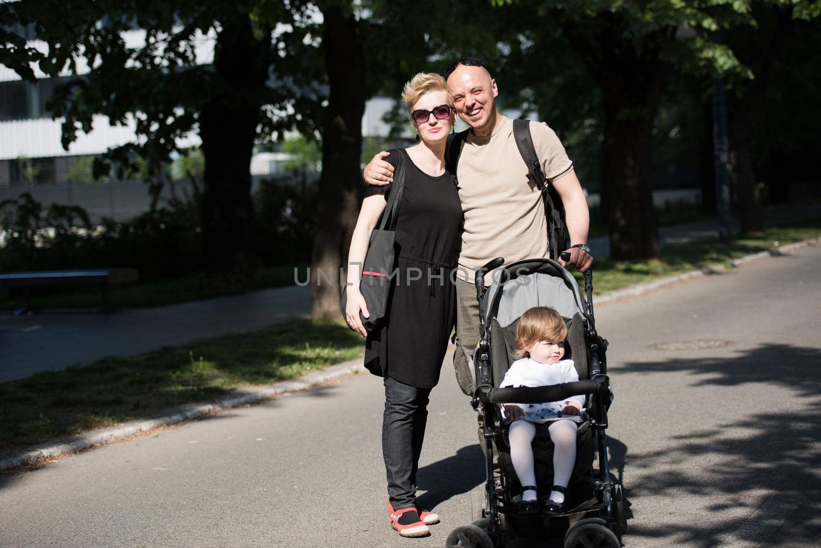 couple with baby pram in summer park by dotshock