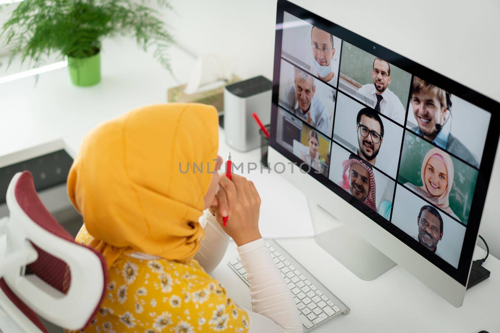 Middle Eastern businesswoman having online conference at home by Zurijeta