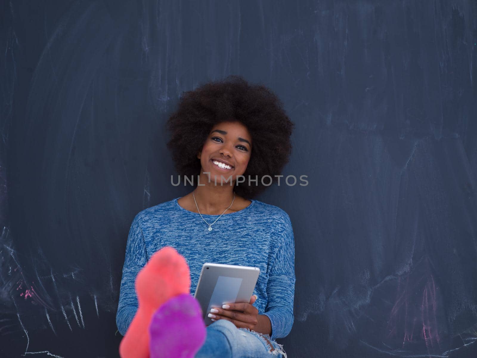 Young Happy African American Woman Using Digital Tablet  Isolated on a gray background