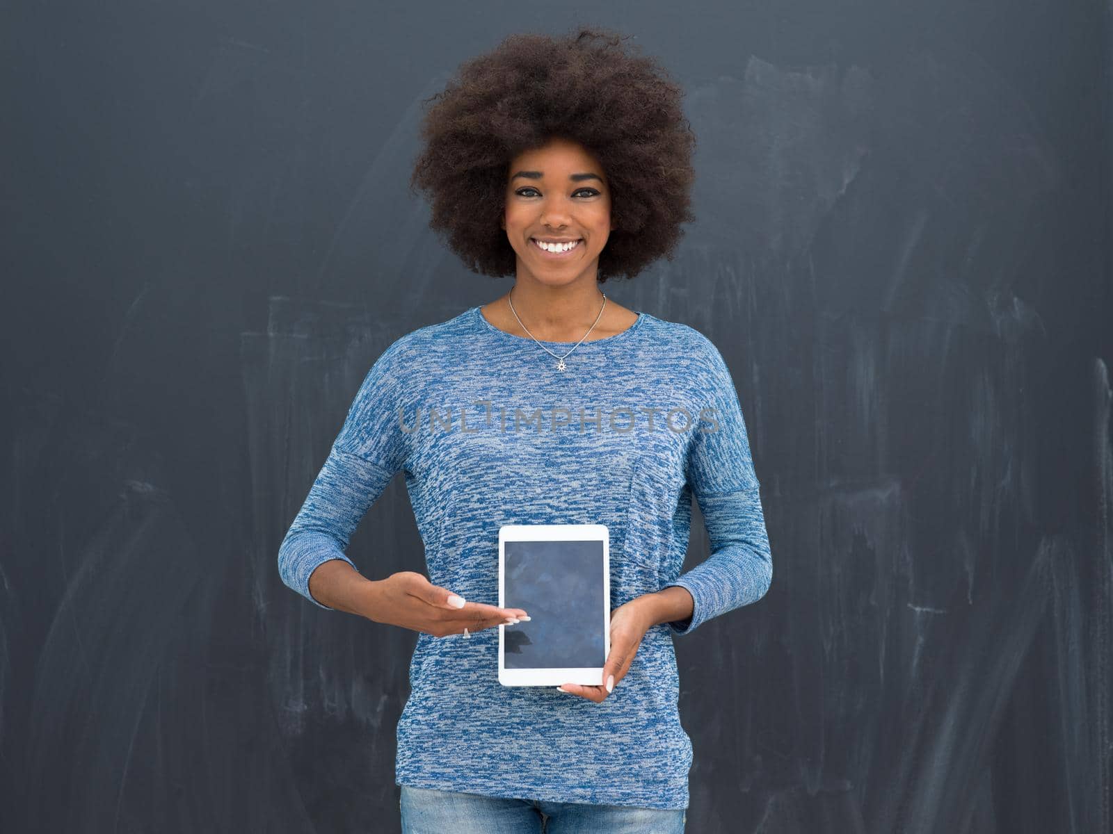 Young Happy African American Woman Using Digital Tablet  Isolated on a gray background