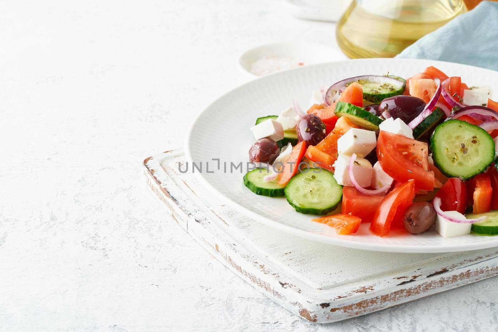 Greek village salad horiatiki with feta cheese, olives, cherry tomato, cucumber and red onion by NataBene