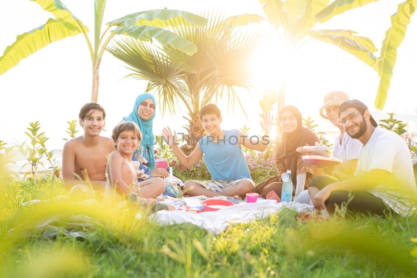 Happy family enjoying picnic on beach near sea