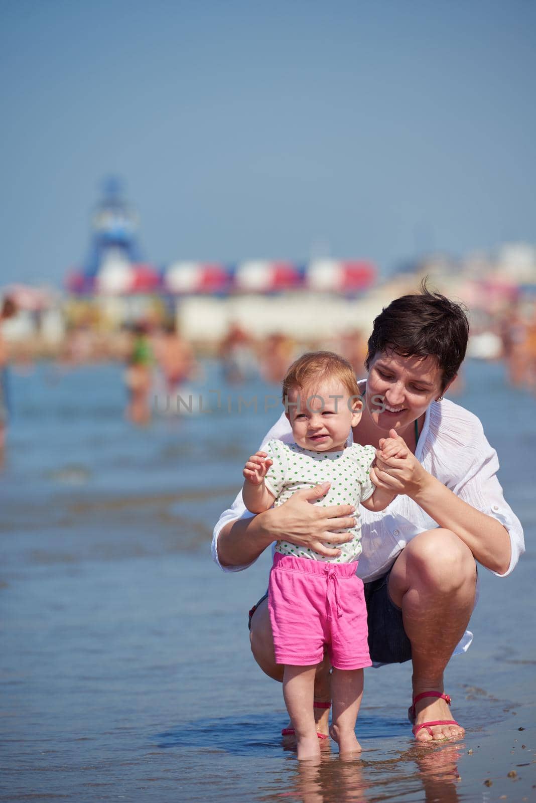 mom and baby on beach  have fun by dotshock