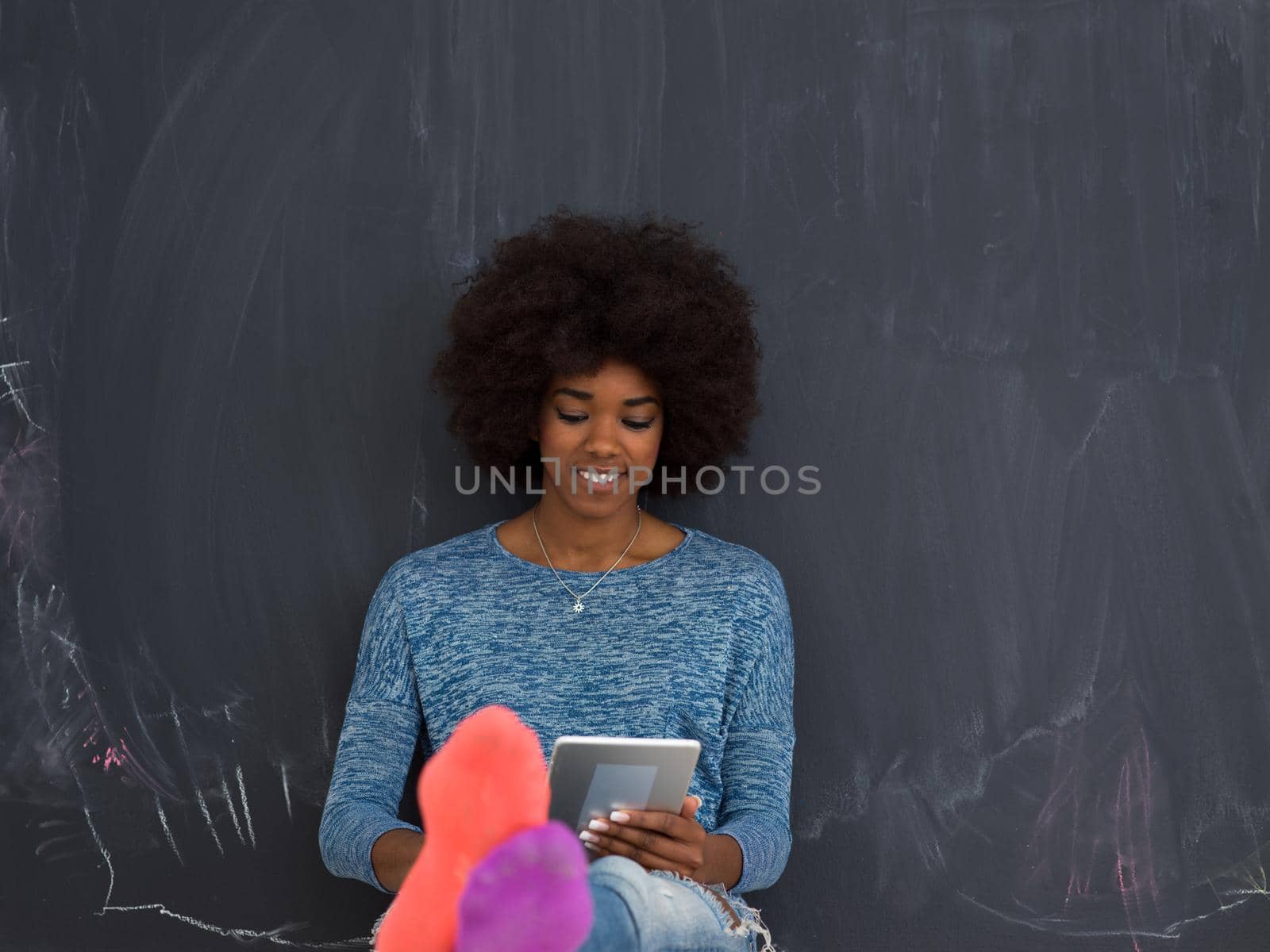 Young Happy African American Woman Using Digital Tablet  Isolated on a gray background