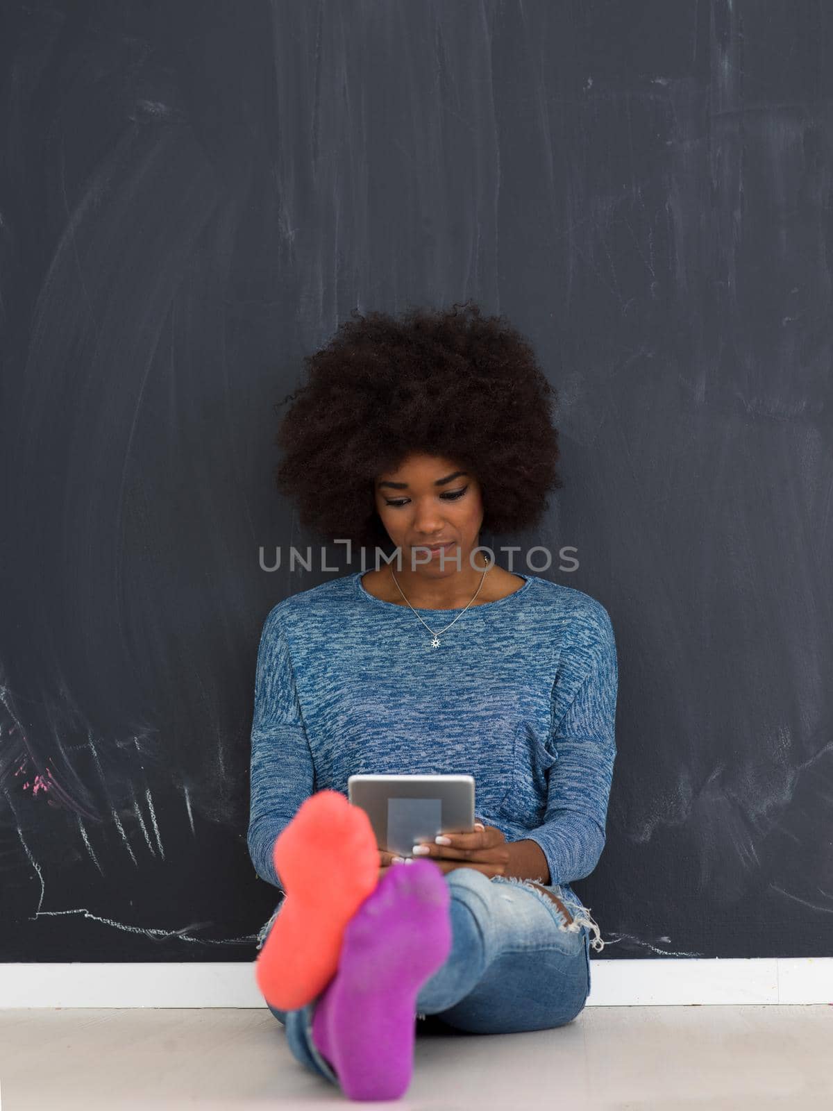 Young Happy African American Woman Using Digital Tablet  Isolated on a gray background