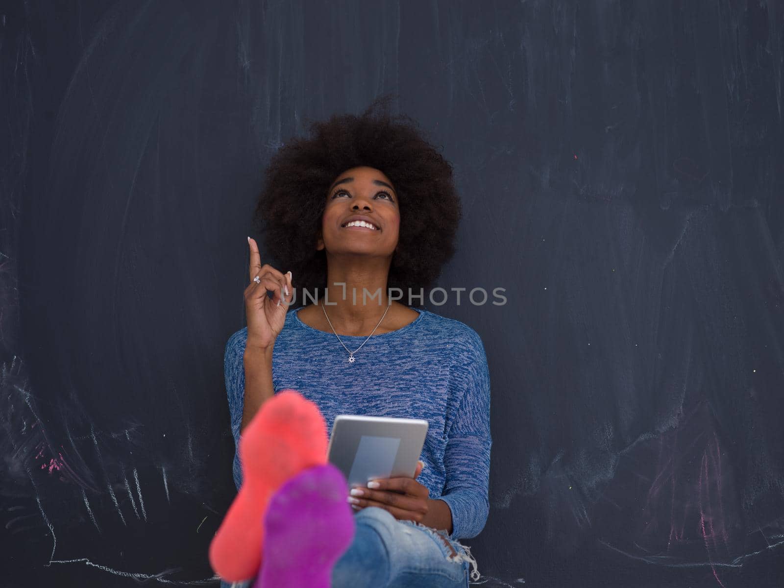 Young Happy African American Woman Using Digital Tablet  Isolated on a gray background