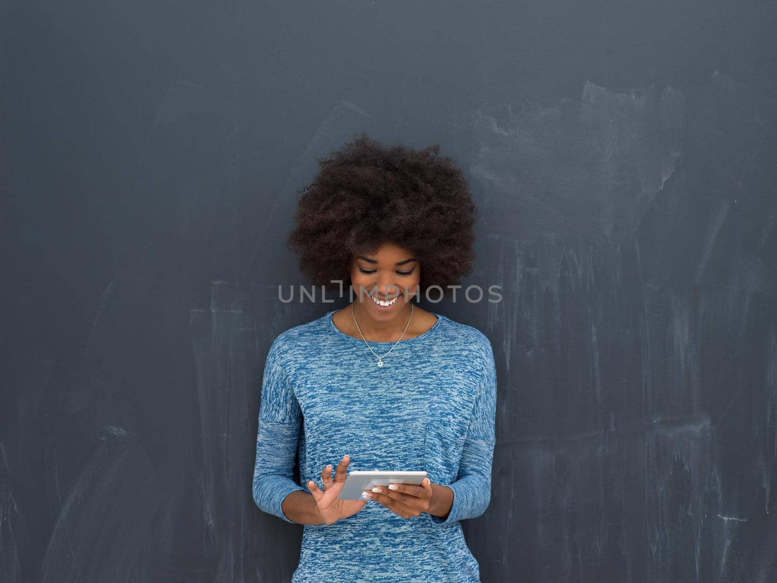 Young Happy African American Woman Using Digital Tablet  Isolated on a gray background