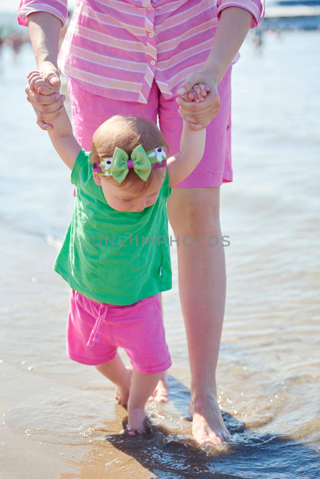 mom and baby on beach  have fun by dotshock