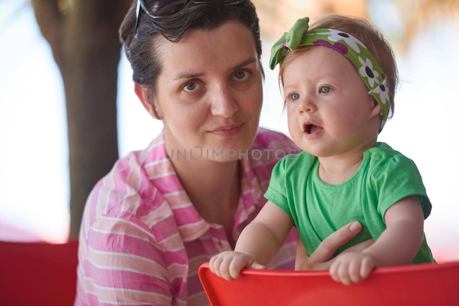 portrait of happy young mother and baby  while have  fun