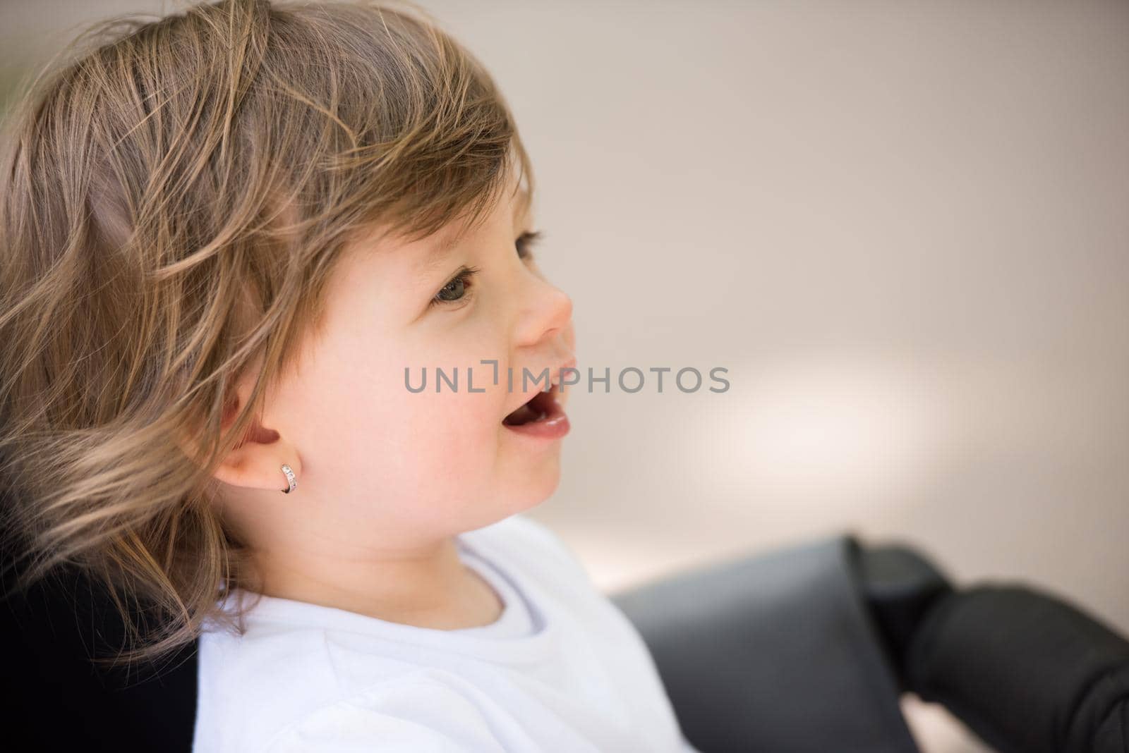 little and very beautiful baby girl sitting in the pram and waiting for mom