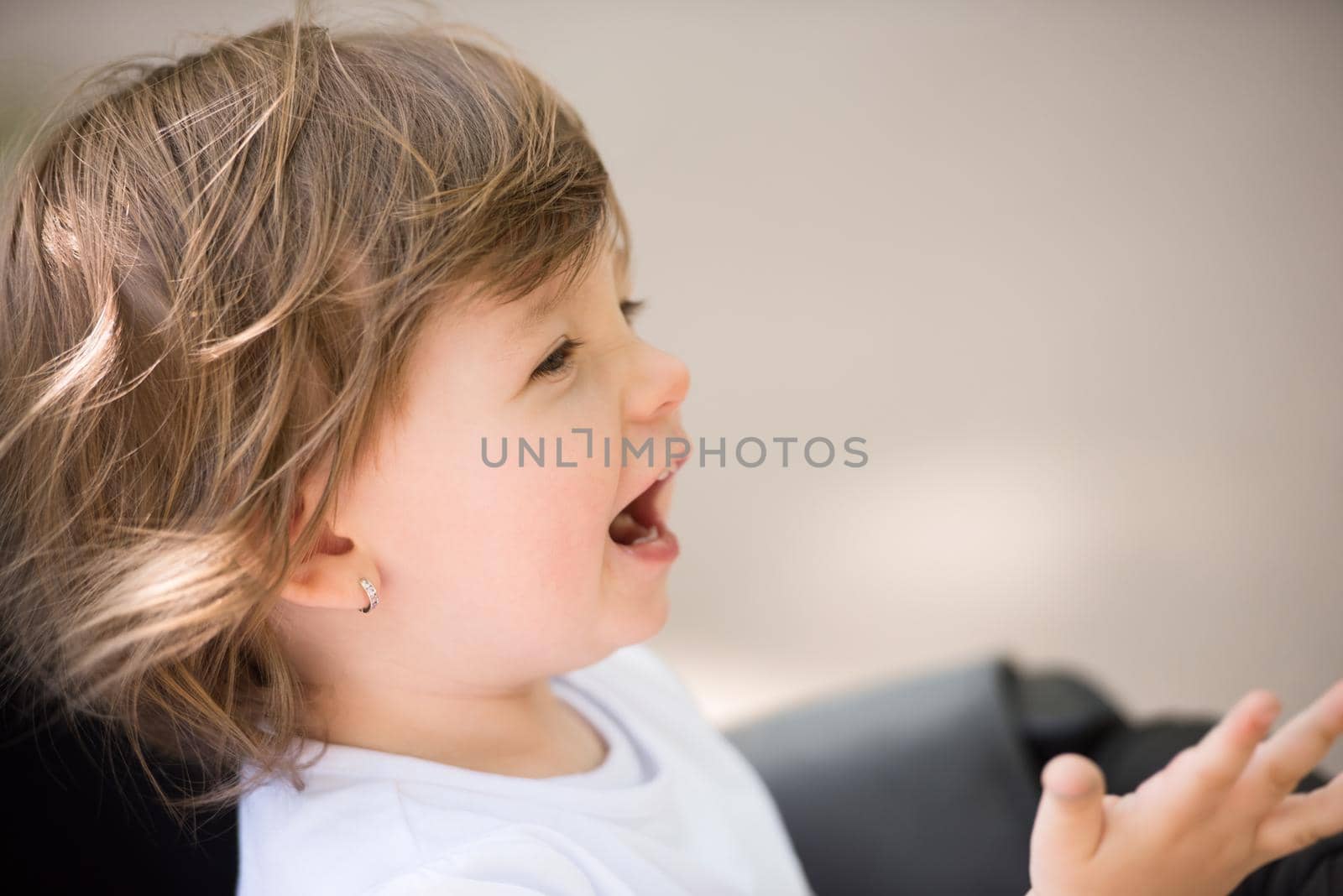 little and very beautiful baby girl sitting in the pram and waiting for mom