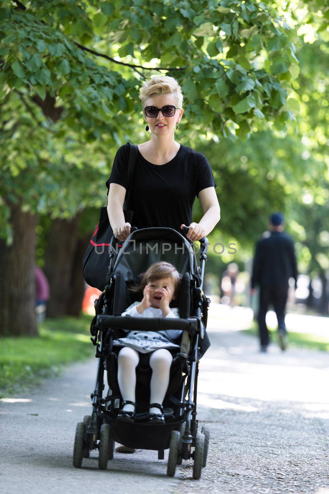 mother pushed her baby daughter in a stroller by dotshock