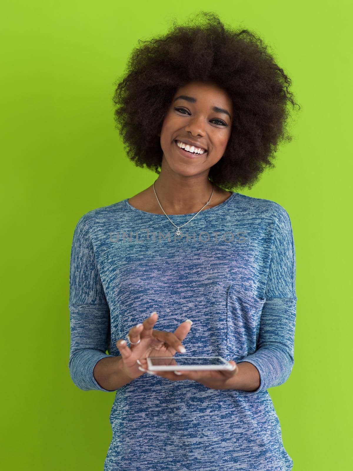 Young Happy African American Woman Using Digital Tablet  Isolated on a green background