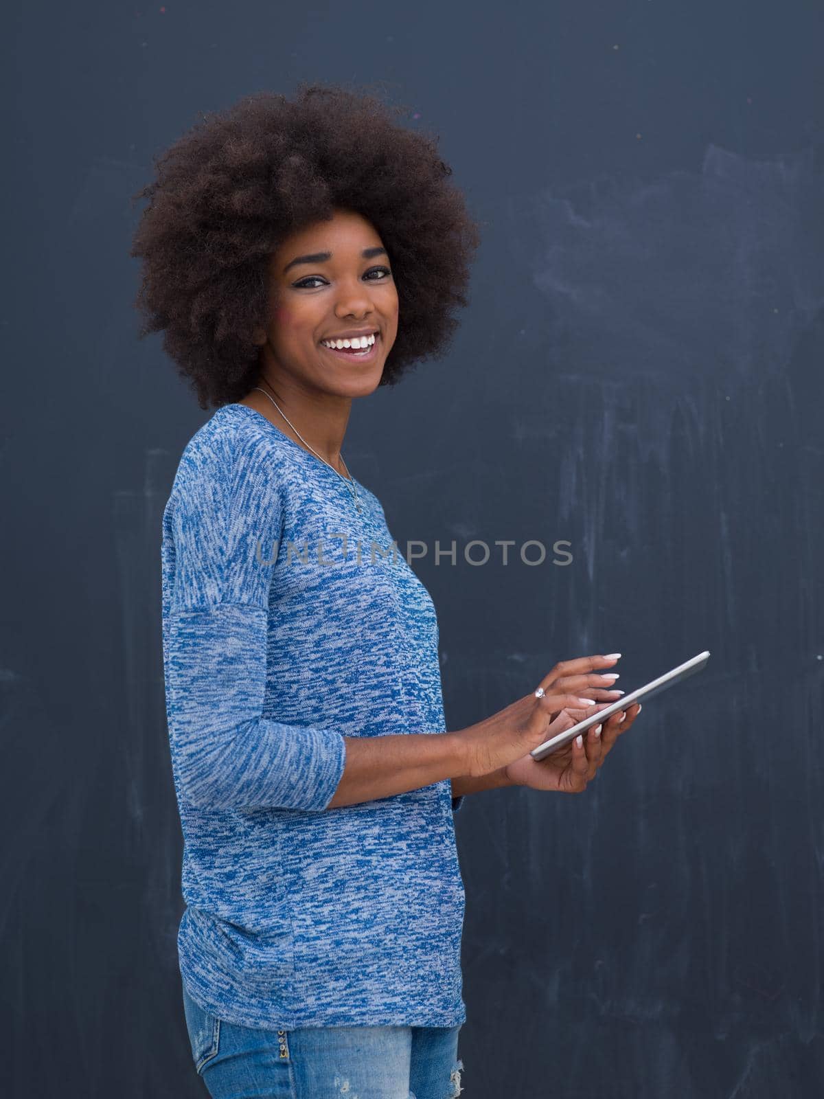 Young Happy African American Woman Using Digital Tablet  Isolated on a gray background