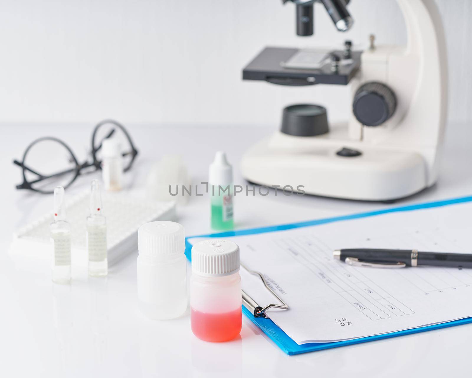 Pandemic COVID-19, Coronavirus. Nobody in hospital is on duty, avail for work, filling out forms. Woman in uniform and face mask conducts tests in laboratory, writes down results. Selective focus