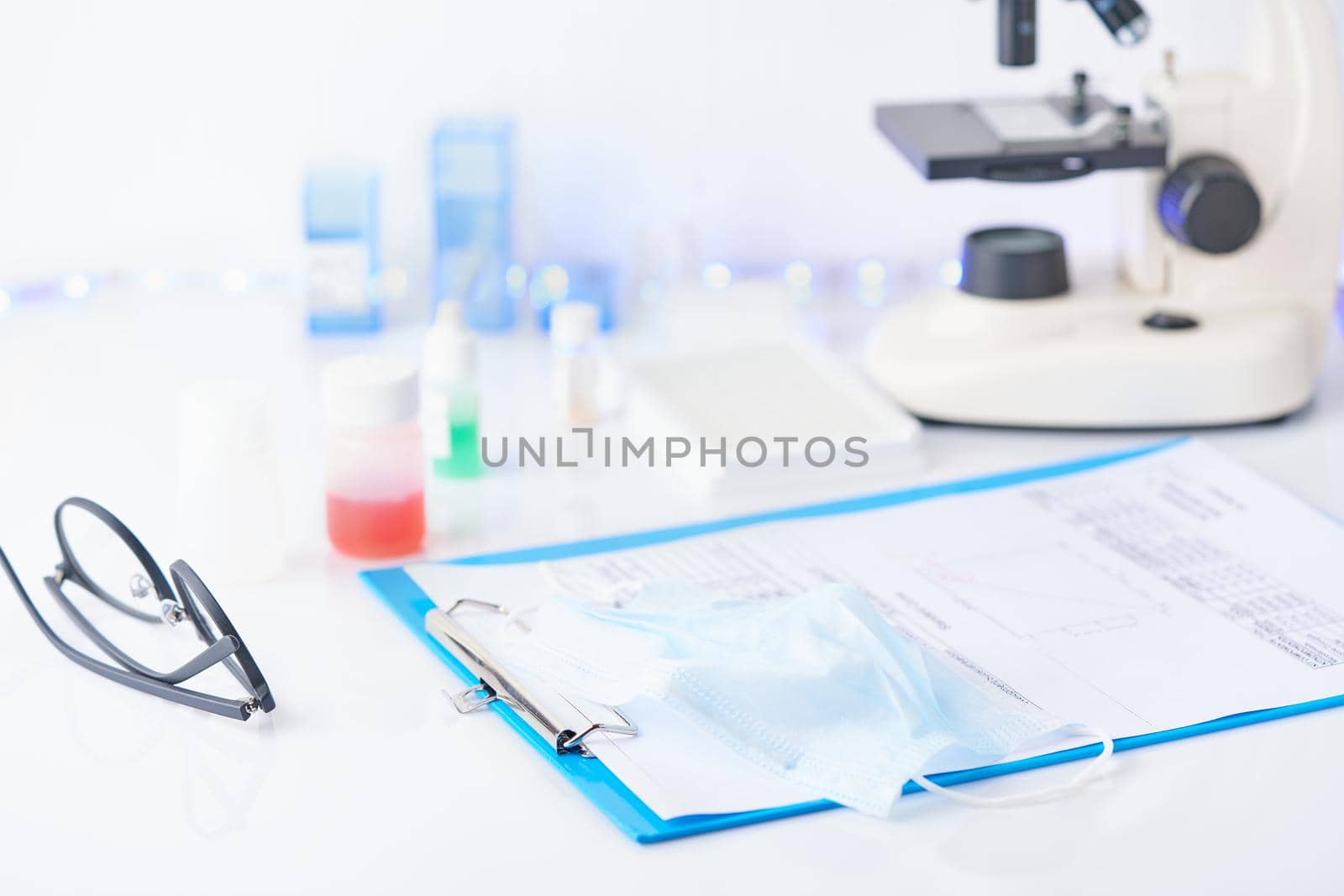 Pandemic COVID-19, Coronavirus. Nobody. Medical supplies, tests, bottles, microscope, clipboard with notes on table. No one is there. Concept of laboratory , development of new drugs and vaccines