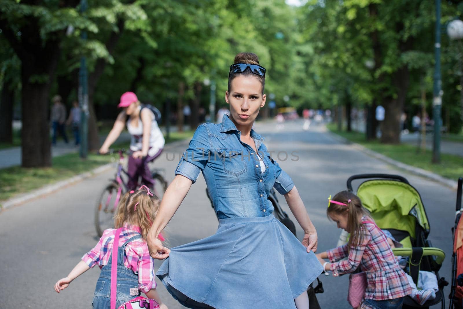 mother with her daughters in the park by dotshock