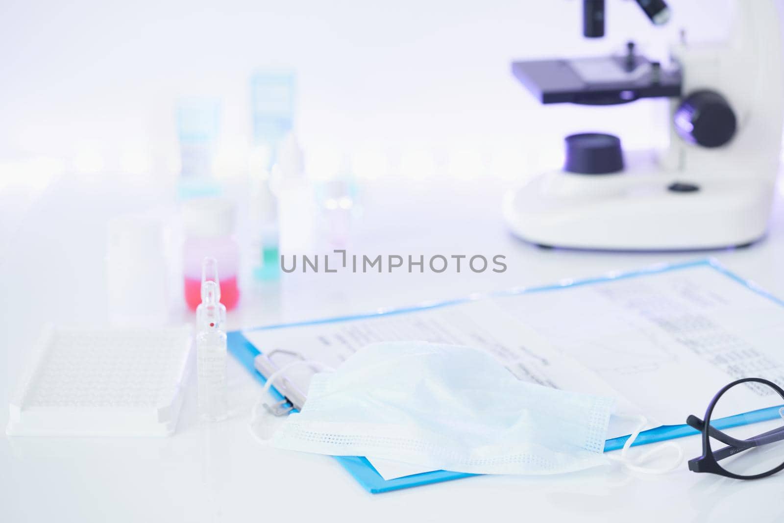 Pandemic COVID-19, Coronavirus. Nobody. Medical supplies, tests, bottles, microscope, clipboard with notes on table. No one is there. Concept of laboratory , development of new drugs and vaccines