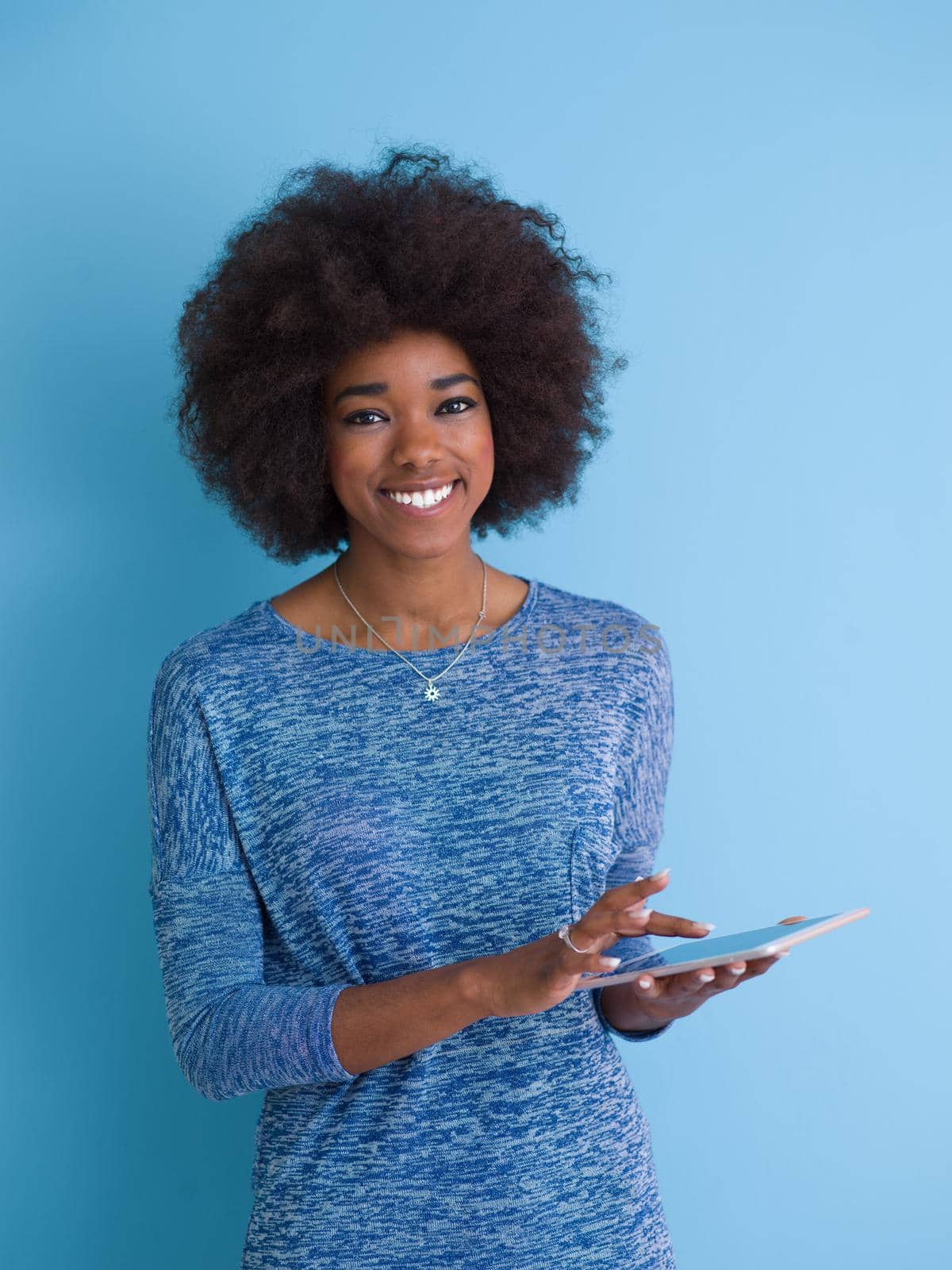 Young Happy African American Woman Using Digital Tablet  Isolated on a blue background