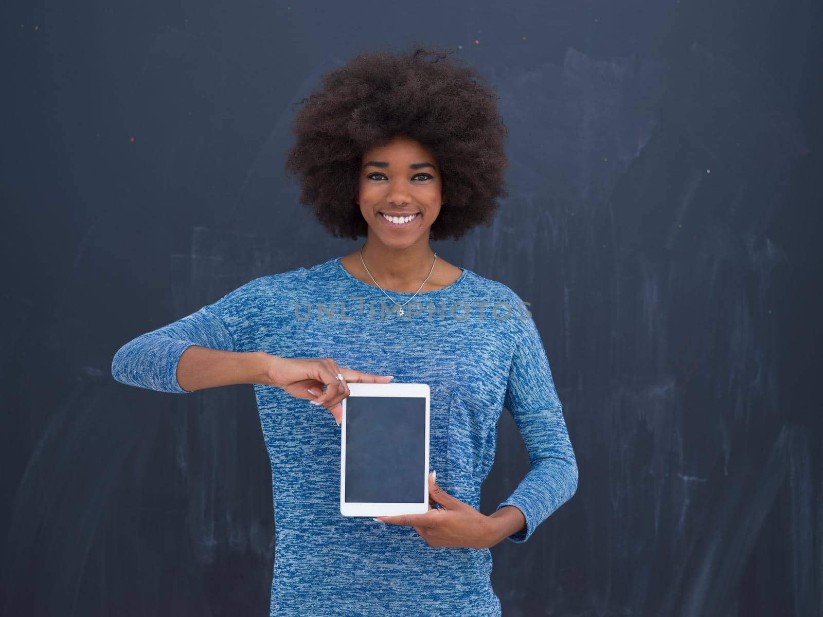 Young Happy African American Woman Using Digital Tablet  Isolated on a gray background