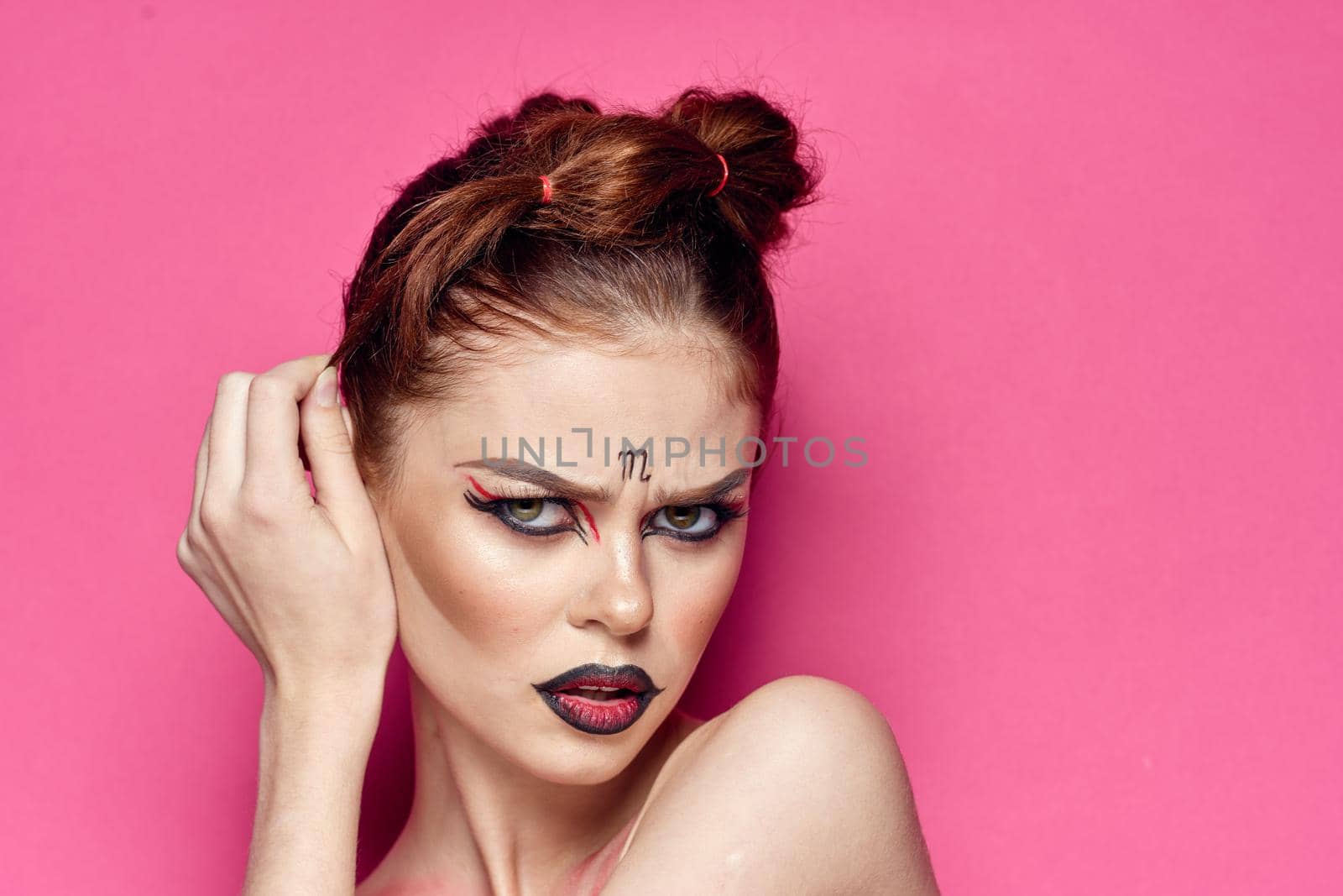 attractive woman naked shoulders cosmetics bright makeup pink background. High quality photo